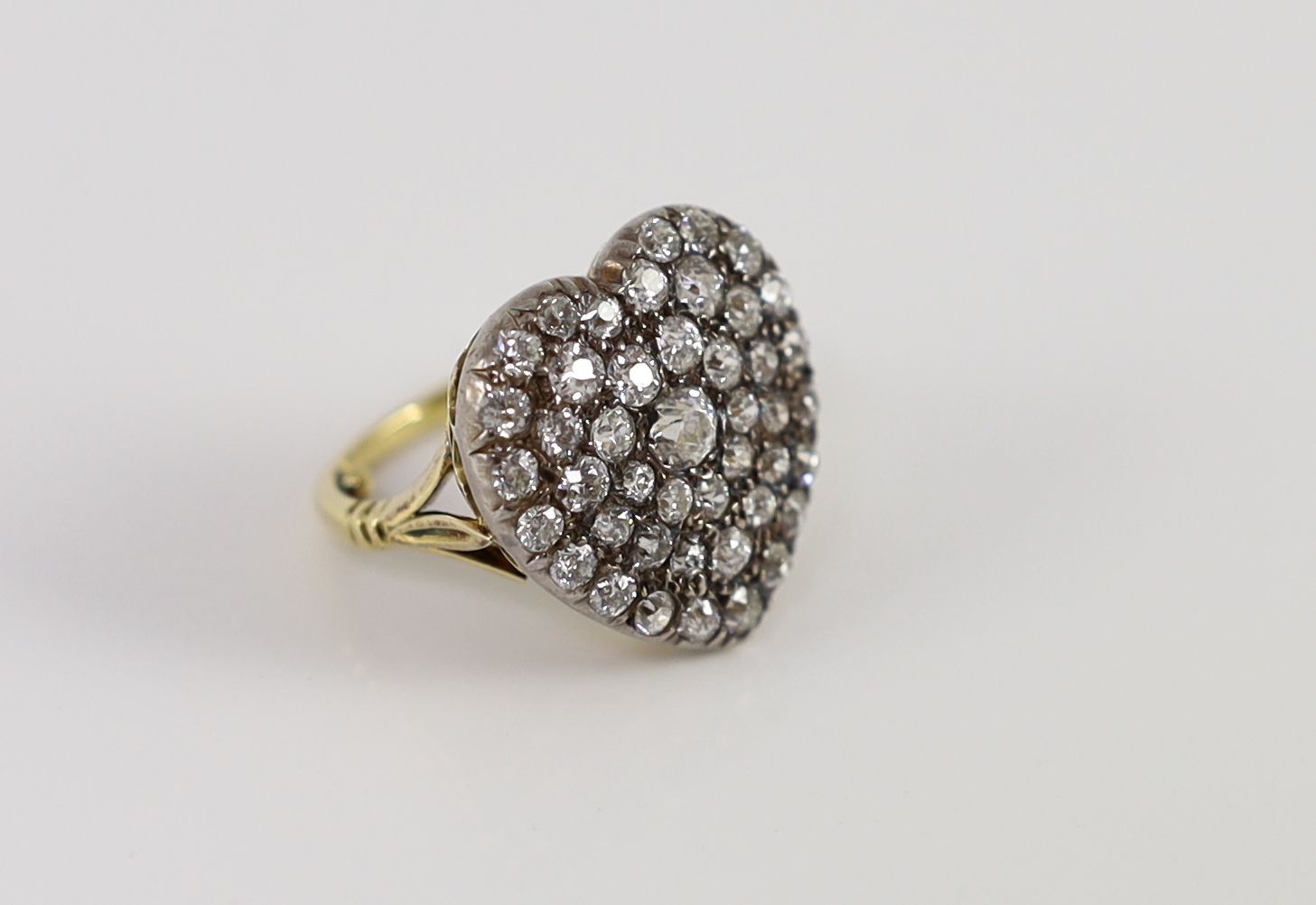 PROPERTY FROM THE COLLECTION OF HER ROYAL HIGHNESS THE PRINCESS MARGARET COUNTESS OF SNOWDON: An antique gold, silver and pave set diamond heart shaped dress ring